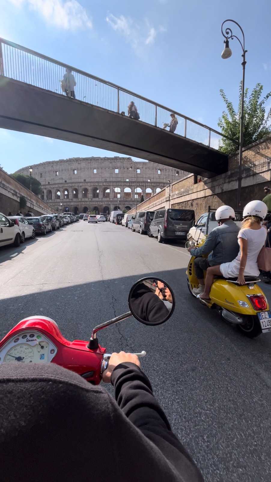 Riding a Vespa toward the Colosseum